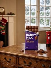 Cadbury Dairy Milk Chocolate 345g with smooth chocolate texture in festive packaging.